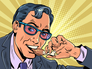 Fototapeta premium Snack or lunch for office workers in their business centers. Convenient and delicious snacks anywhere in the city. A man in a suit and glasses eats a chicken leg. Pop Art Retro