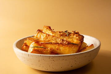 Top view Fried Cassava in Handcrafted White Ceramic Bowl on Yellow Studio Background