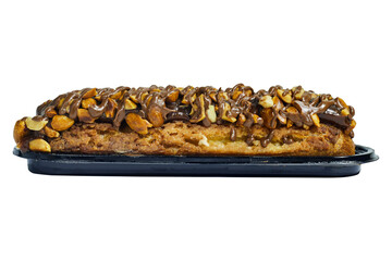Traditional french dessert. Isolated eclair with custard and chocolate icing and peanuts on white background. Pastry products for sweet tooth
