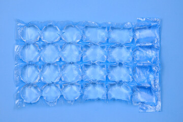 Plastic bag with water for ice close-up. Blue plastic packaging ice bags for home water freezing...