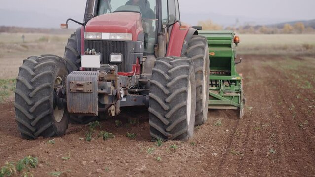 Modern tractor work on agriculture field with Row seed drill grain, slow motion