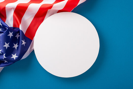 Paying homage to laborers on Labor Day: Capture attention with this top-view image showcasing the American flag on blue background with empty circle perfect for advertisements or text placement