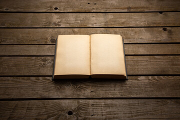 Vintage book, open, on old wooden table, with clipping path. Open Book blank on old wooden back. book with blank pages