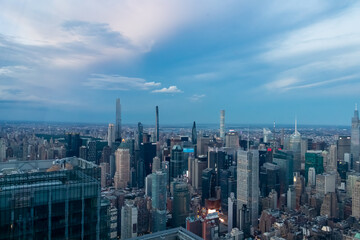 Captivating aerial view of New York City skyline right after the sunset seen from The Edge. The buildings are starting to lit up the lights. Endless rows of buildings. Bustling city. Endless horizon