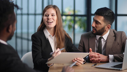 sitting at the table. Young business people working in the office