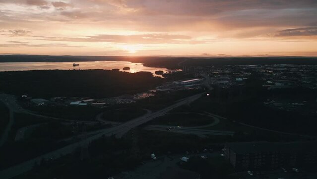 Aerial view of an urban highway junction at a beautiful sunset in Halifax, Canada. Drone shot of an overpass and road junctions in the Canadian town of Dartmouth on a sunny evening.