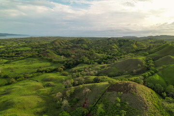 Fototapeta na wymiar AERIAL: Majestic view of vibrant green scenery in hilly Panamanian countryside