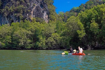 Two people, a guy and a girl, are kayaking in the tropics on the lake, tourism, travel