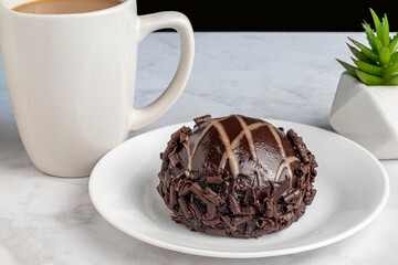 chocolate mousse bomb with a cup of coffee