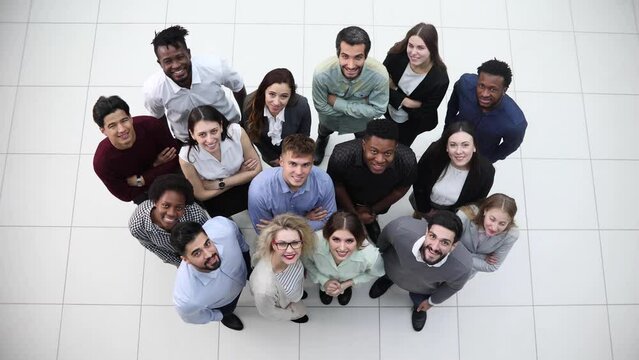 large team of young people pointing somewhere up