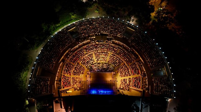 aerial view with drone of people watching concert in open air theater