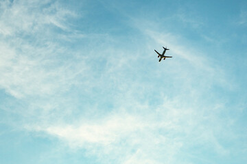 Fototapeta na wymiar Blue sky with an airplane.