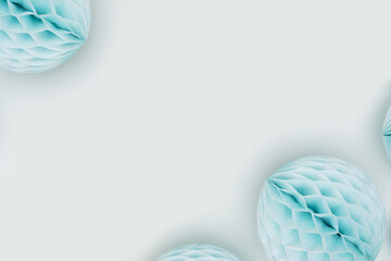 Tissue paper balls scattered on a blue background. Creative festive concept with copy space.