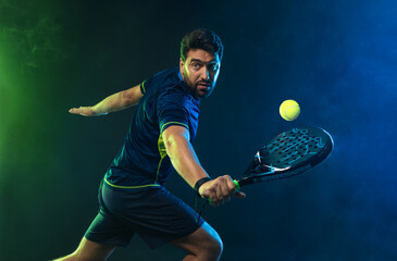 Padel Tennis Player with Racket in Hand. Paddle tenis, on a blue background. Download in high resolution. - obrazy, fototapety, plakaty