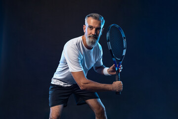 Old man. Tennis player banner on the black background. Tennis template for ads with copy space....