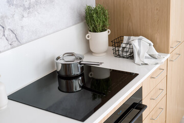 contemporary glass ceramic hob with saucepan, household appliances concept