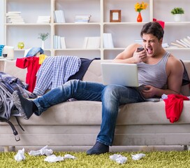 Young man working studying in messy room