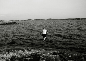 Man jumping into water