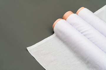 Set in a tranquil minimalistic environment, the mockup of a white fabric roll image exudes...