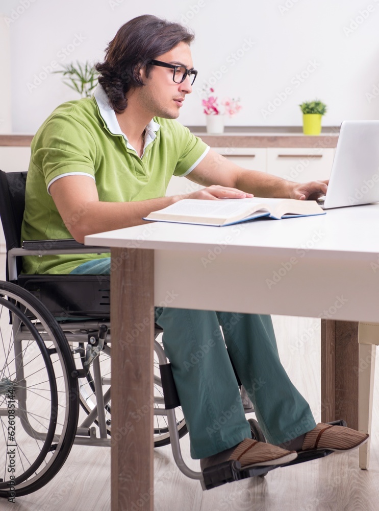 Wall mural Young male student in wheelchair at home