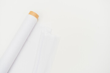 The serene and elegant ambiance of a minimalistic environment elevates the mockup display of the white fabric roll image