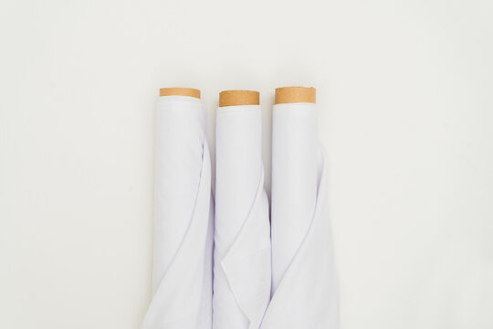 In a carefully curated minimalistic presentation, the mockup of the white fabric roll image exudes sophistication