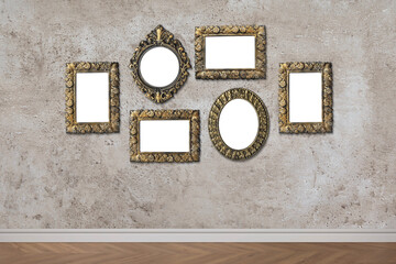 Blank vintage frames hanging on gray textured wall. Mockup for design