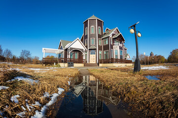 In winter, the wooden villa is under the blue sky