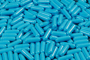 Blue antibiotic capsule pills texture. Pharmaceutical production. Global health. Resistance to...