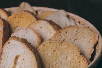 Delicious croutons. Pieces of roasted white bread. Sliced bread closeup. Croutons in the wicker basket.