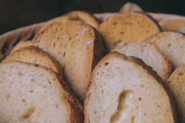 Delicious croutons. Pieces of roasted white bread. Sliced bread closeup. Croutons in the wicker basket.