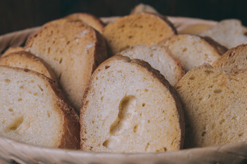 Delicious croutons. Pieces of roasted white bread. Sliced bread closeup. Croutons in the wicker basket.
