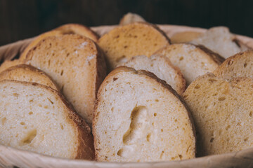 Delicious croutons. Pieces of roasted white bread. Sliced bread closeup. Croutons in the wicker basket.