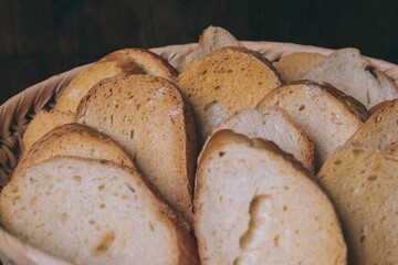 Delicious croutons. Pieces of roasted white bread. Sliced bread closeup. Croutons in the wicker basket.