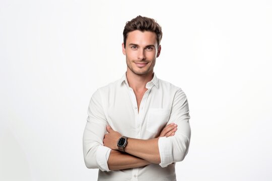 a portrait photo of a handsome businessman guy in a white shirt having his arms folded and watching forward in the camera. white background. studio photography for ads. Generative AI