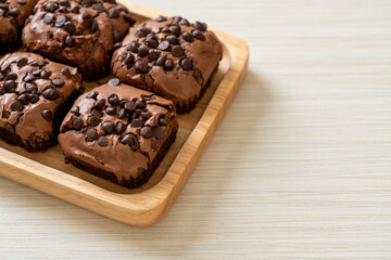 dark chocolate brownies topped by chocolate chips