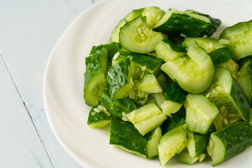 Fresh chopped cucumber isolated on white background