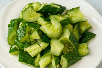 Fresh chopped cucumber isolated on white background