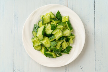 Fresh chopped cucumber isolated on white background