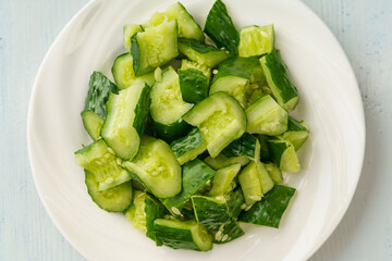 Fresh chopped cucumber isolated on white background
