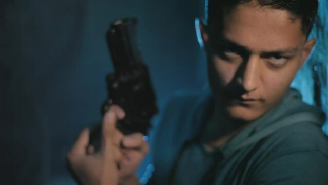 Shadowed Valor - Military Official in Black Jacket with Gun - Intriguing Two-Faced Lighting Technique Adds Drama and Depth - HD Stock Footage. SOC
