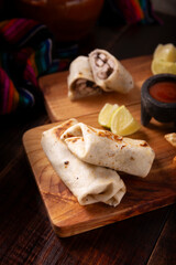 Burrito. Wrapped wheat flour tortilla, can be filled with various ingredients such as scrambled eggs or minced meat, beans and vegetables, a very popular dish in Mexico and the southern USA.