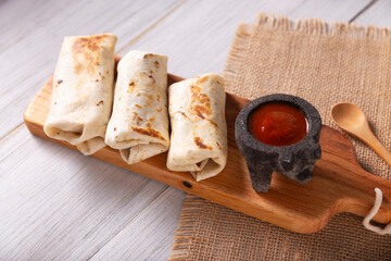 Burritos. Wrapped wheat flour tortilla, can be filled with various ingredients such as scrambled eggs or minced meat, beans and vegetables, a very popular dish in Mexico and the southern USA.