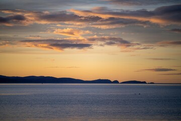 beautiful bruny island at dawn with pink clouds and the ocean below