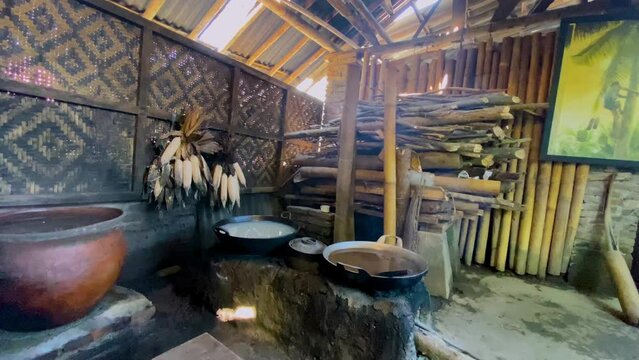Scene of traditional javanese kitchen. Coconut sap on the pan placed on the traditional Javanese wood-fired fire stove. The process of cooking coconut sap for making of Javanese sugar or brown sugar