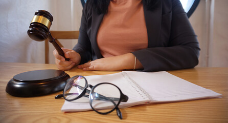 Legal counsel presents to the client a signed contract with gavel and legal law. Justice and lawyer...