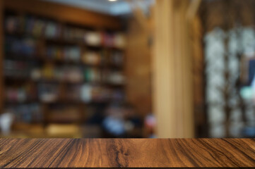 Empty dark wooden table in front of abstract blurred boken bankground of restaurant.	