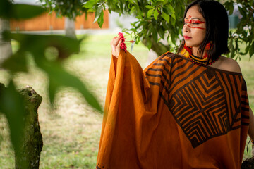 beautiful young peruvian woman of the yanesha culture posing with dresses, jewelry, makeup, clothes...