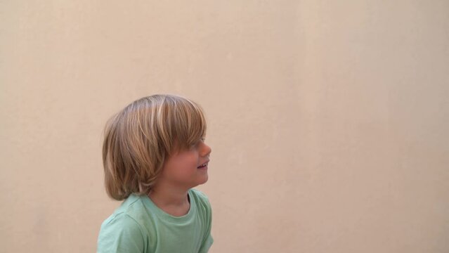 Beautiful Blond 3s Boy Playing With Confetti. Child With Confetti And Streamers, Happy And Smiling.Handheld clip