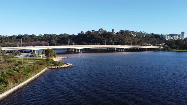 Drone Aerial View of South Perth foreshore along Swan River ascending over Narrows Bridge with Freeway to Kings Park